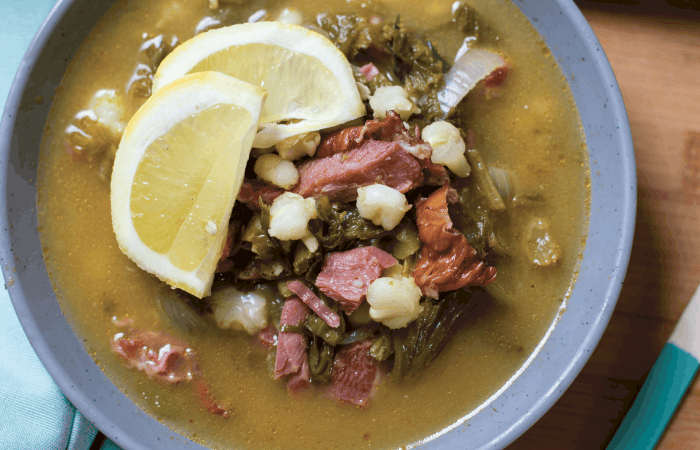 Overhead close up shot of Lemony Southern Style Posole garnished with slices of lemon.