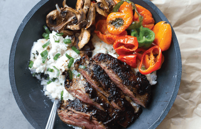 Coffee Crusted Skirt Steak served with peppers, mushrooms and grits