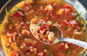 Overhead shot of Bermuda Inspired Fish Chowder in a bowl with a spoonful of the fish chowder.