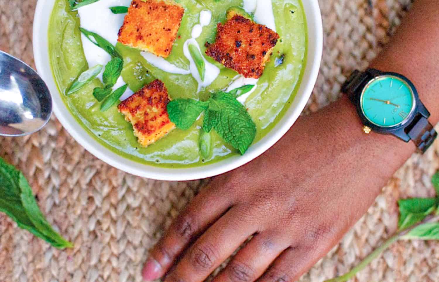 close up overhead shot of bowl of pea mint soup with cornbread croutons