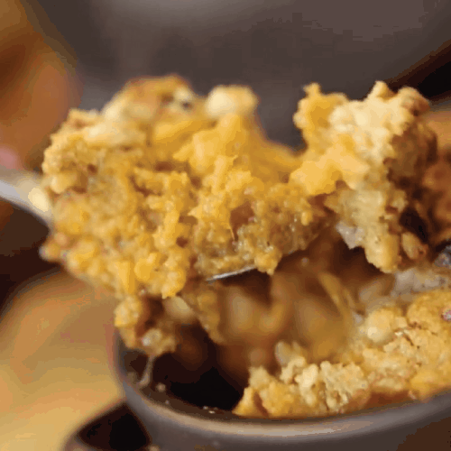 Spoon scooping some Candied Yam Casserole with Brown Sugar Streusel