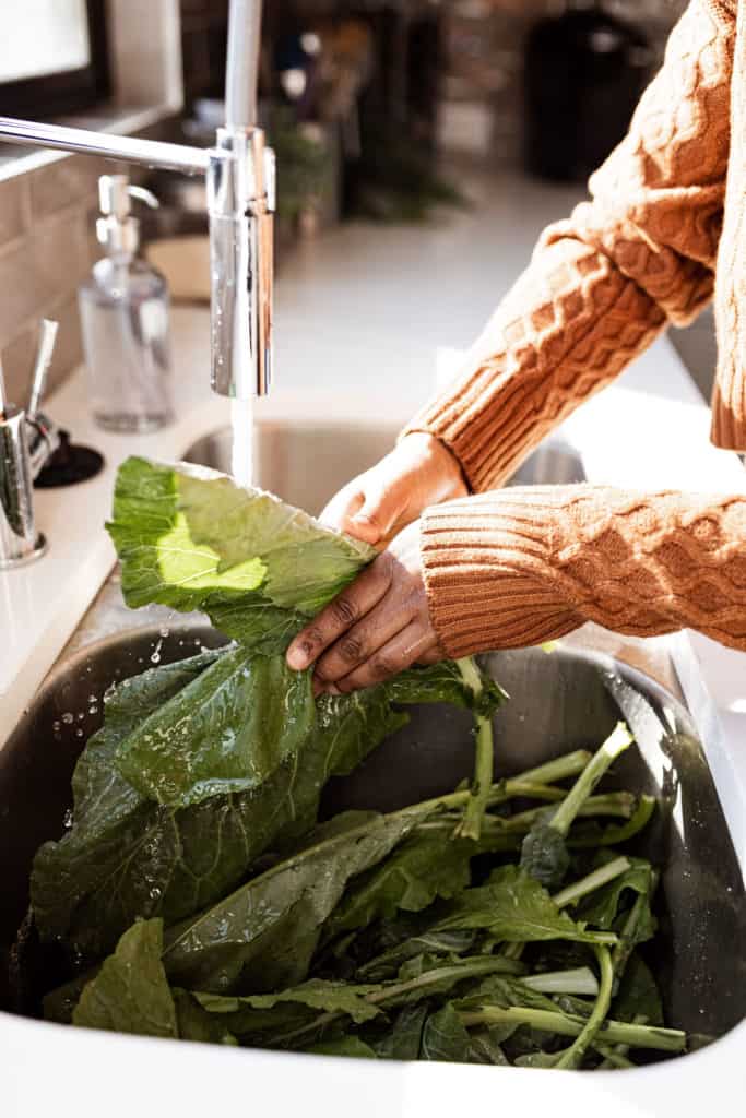 Cleaning greens in kitchen sink