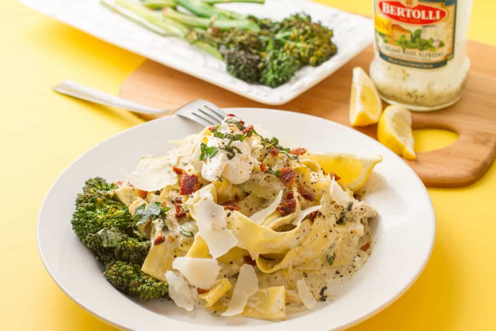 Bertolli creamy basil alfredo pappardelle with bacon pieces and Shaved Parmesan on top baby broccoli