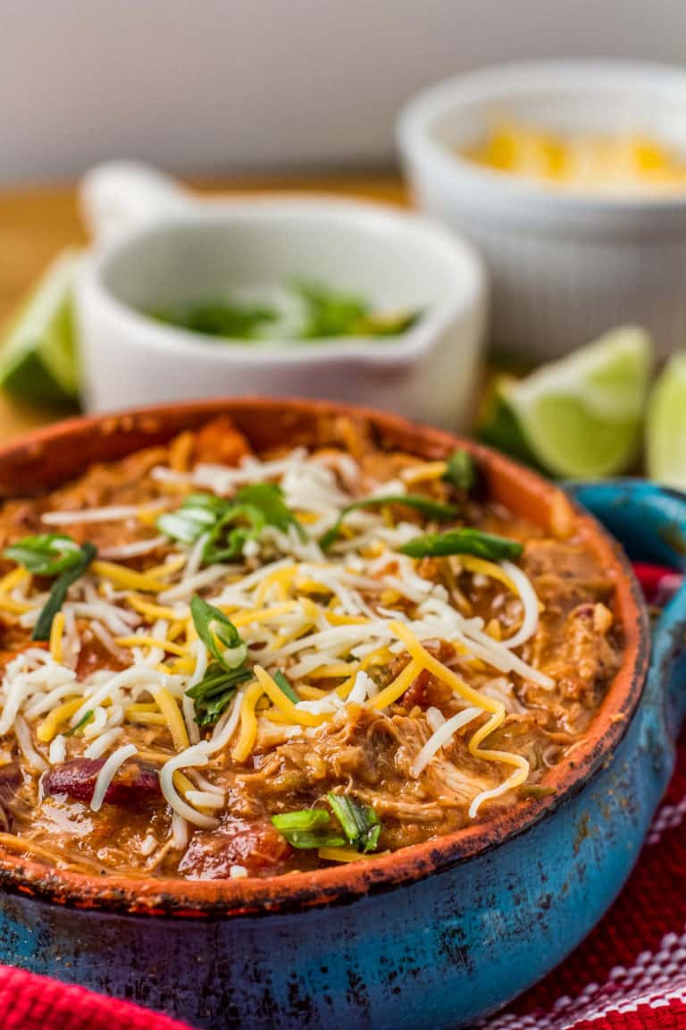 bowl of pulled chicken chili topped with cheese