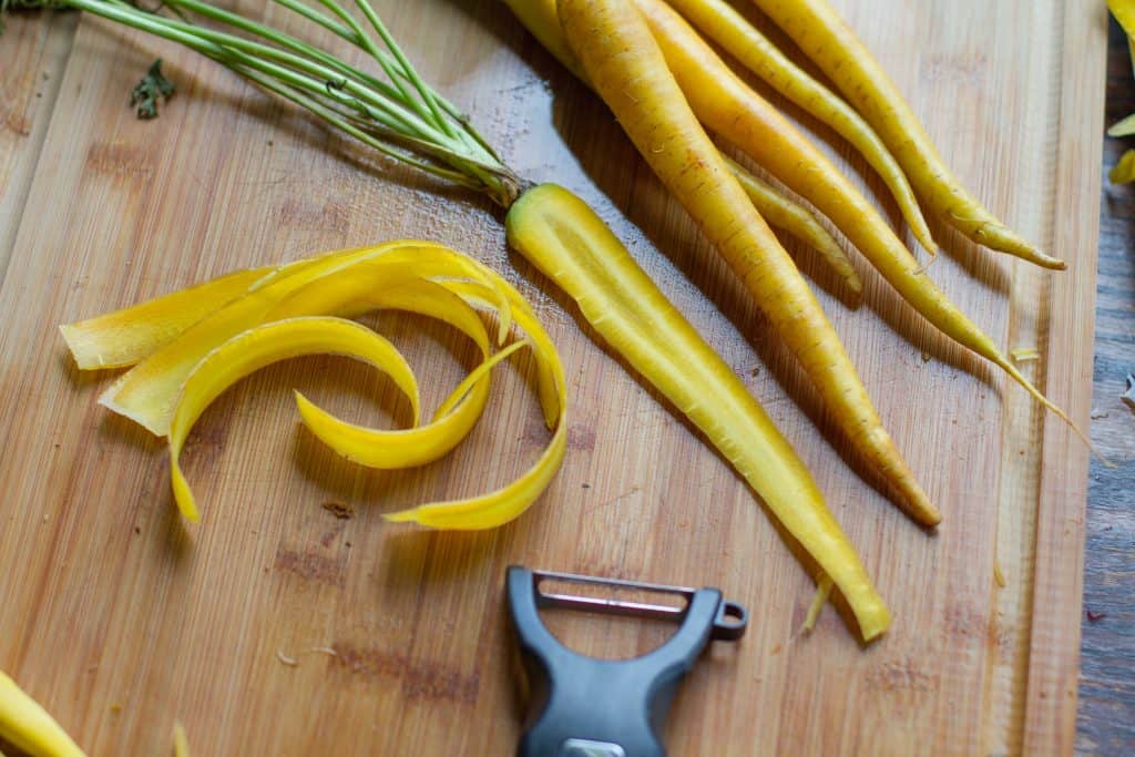 Shaved yellow Carrots on chopping board