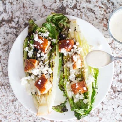 Crispy grilled romaine drizzled with a homemade smoky Caesar dressing totally elevates the traditional Caesar salad.