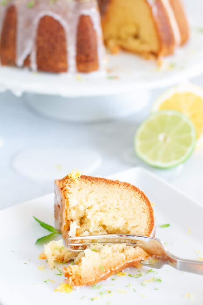 A slice of 7up Pound cake drizzled with 7up glaze on a plate with a fork.