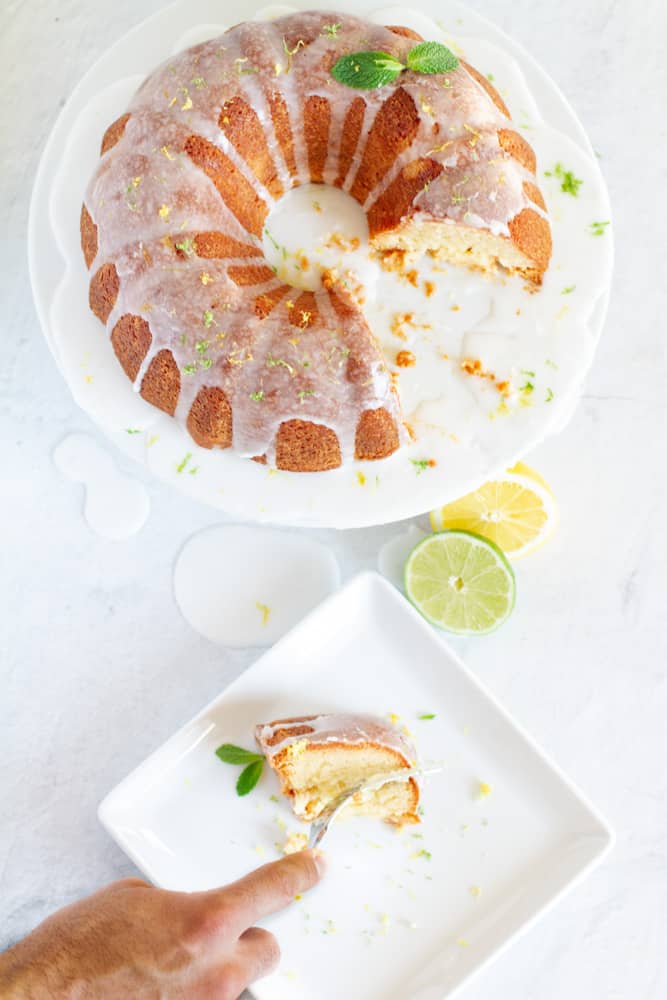 An aerial slice of the 7up Pound cake drizzled with 7up glaze and a fork in hand
