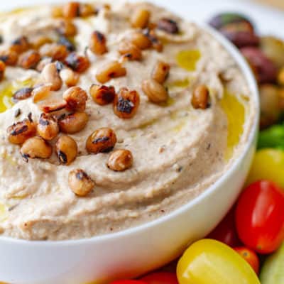 Close up of Black eyed Pea Hummus with platter of vegetables