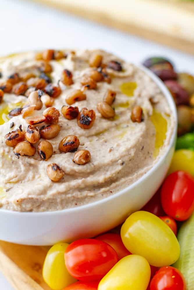 Close up of Black eyed Pea Hummus with platter of vegetables