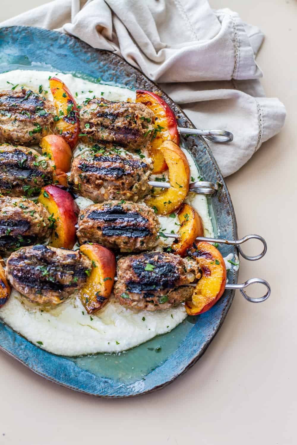 turkey kefta & peach kabobs on top of whipped feta