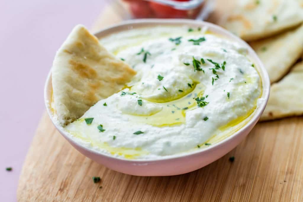 whipped feta in bowl with pita bread