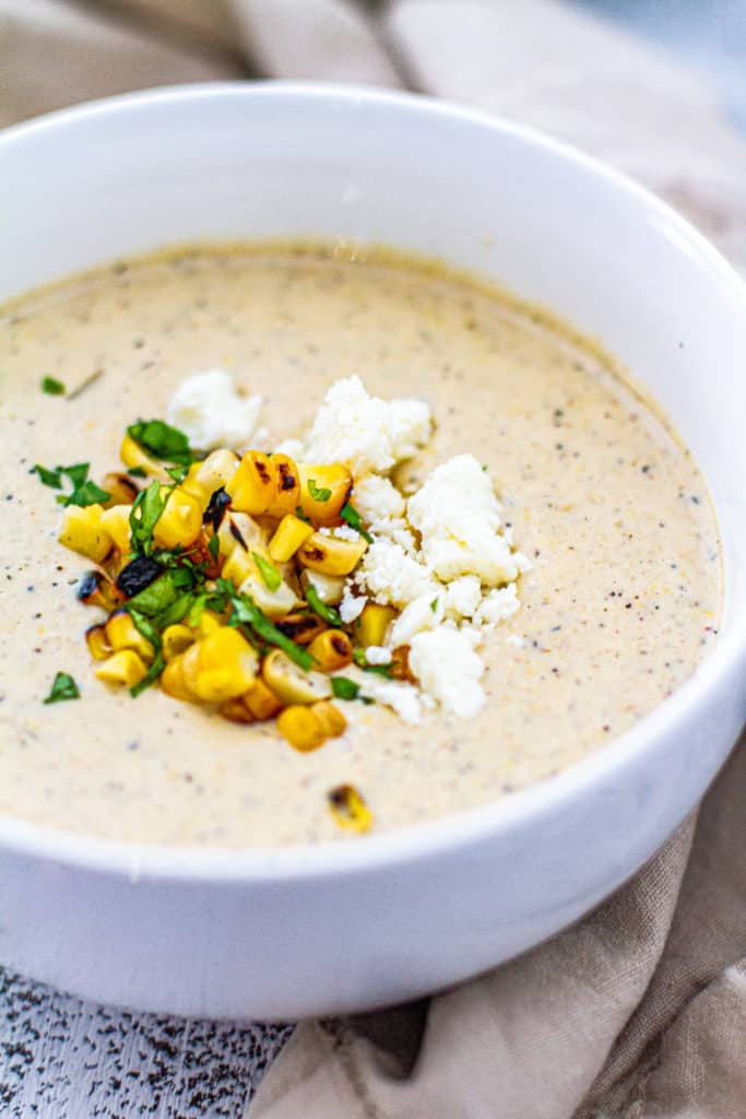 elote corn chowder in a white bowl