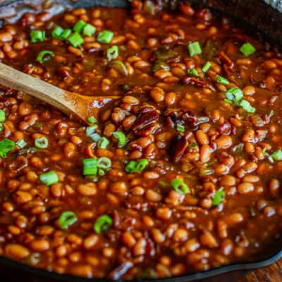 baked beans in cast iron with wooden spoon