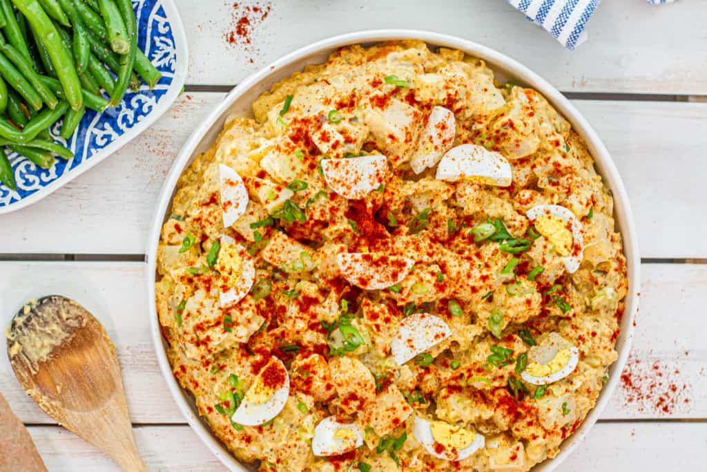 Southern Potato Salad on picnic table with other sides