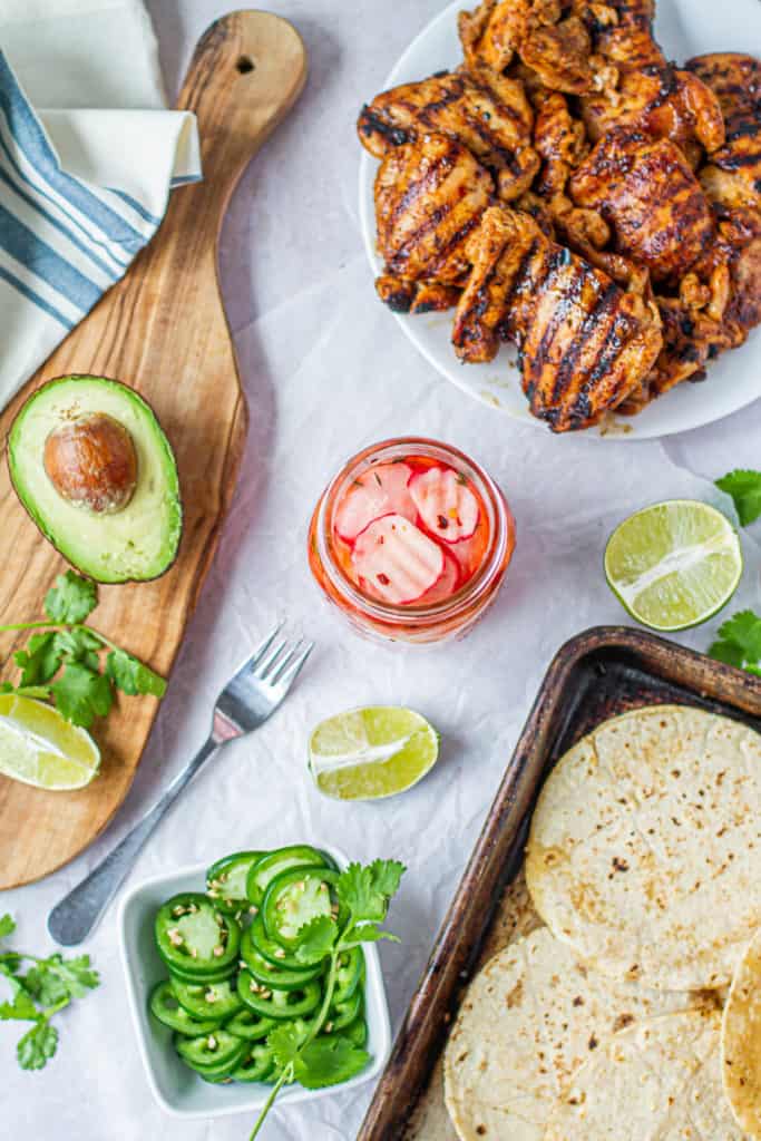 toppings for tacos, pickled radishes, avocados, jalapenos, margarita chicken and tortillas