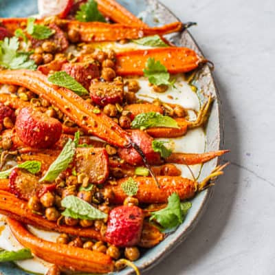 Close up of platter with moroccan-spiced carrot & radish salad over a napkin