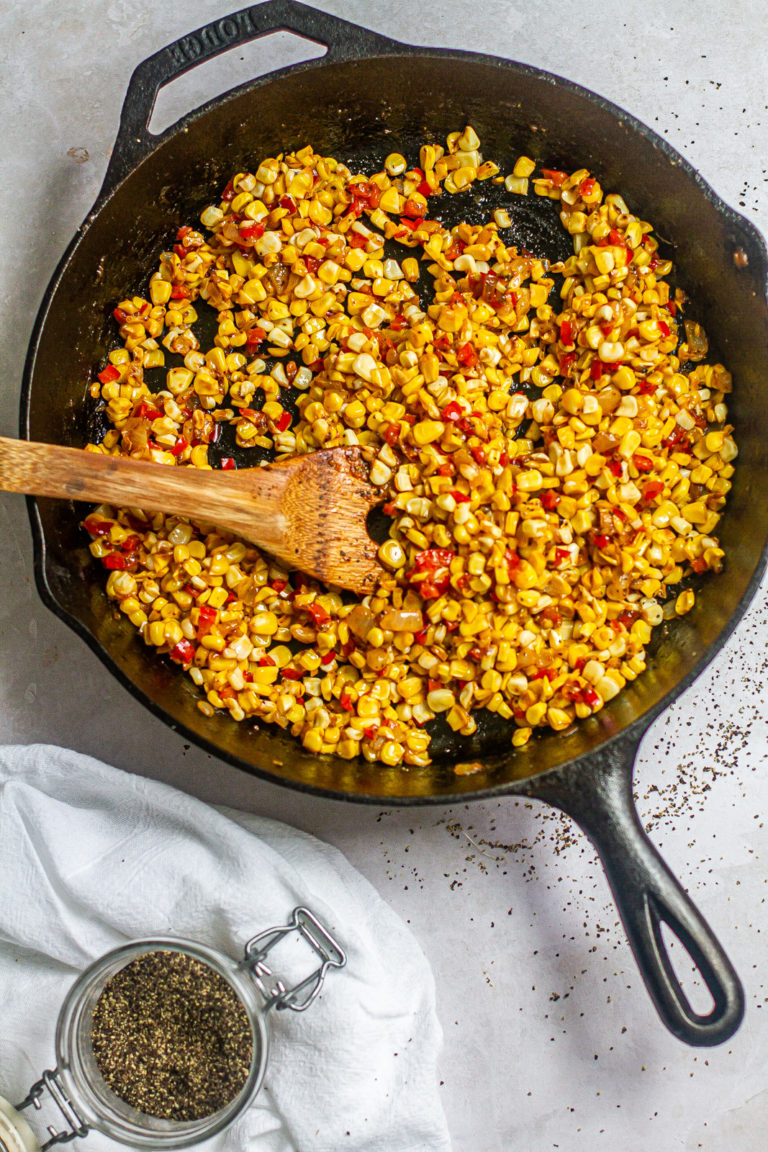 fried corn in skillet with black pepper on top