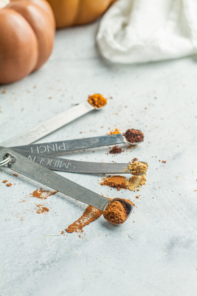spices for homemade pumpkin spice in measuring spoons