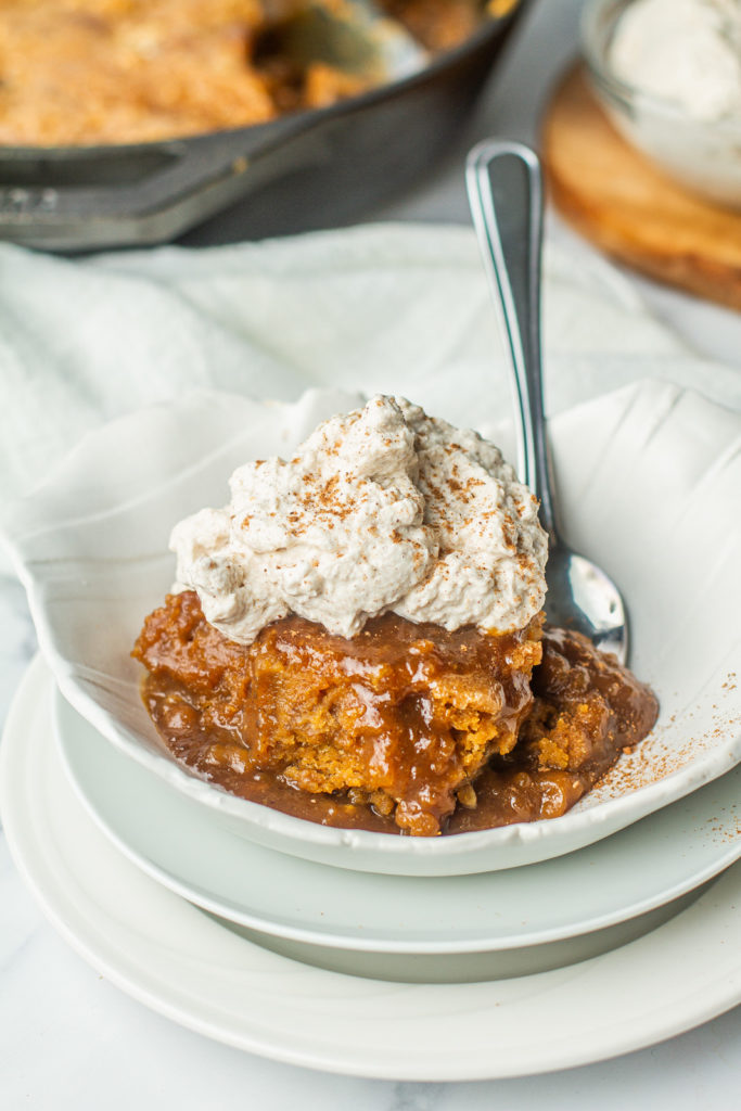 warm self saucing pumpkin pudding with whipped cream on top