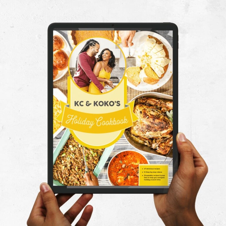 Hands holding tablet with KC and KOKO HOLIDAY COOKBOOK on screen