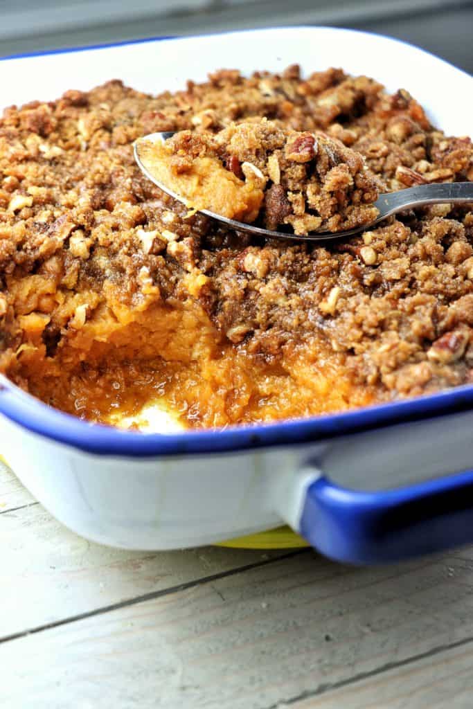 Yam Casserole in casserole dish with a spoon