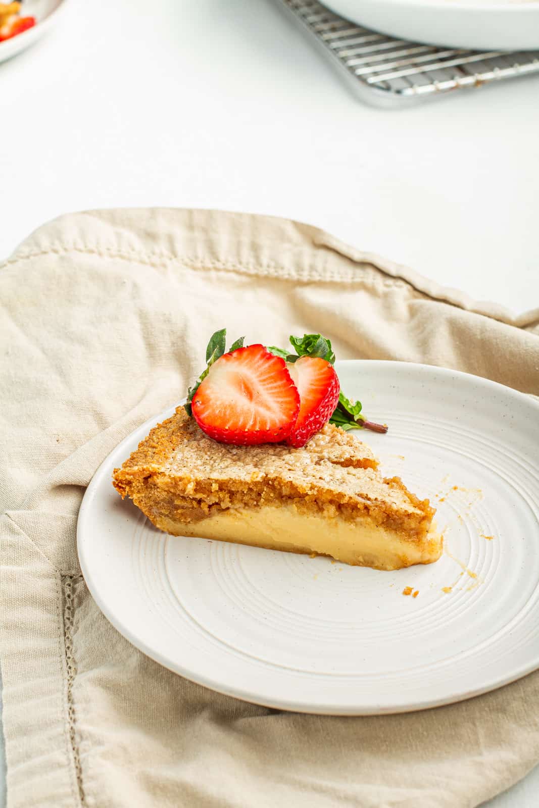 slice of goat milk pie topped with fresh strawberries