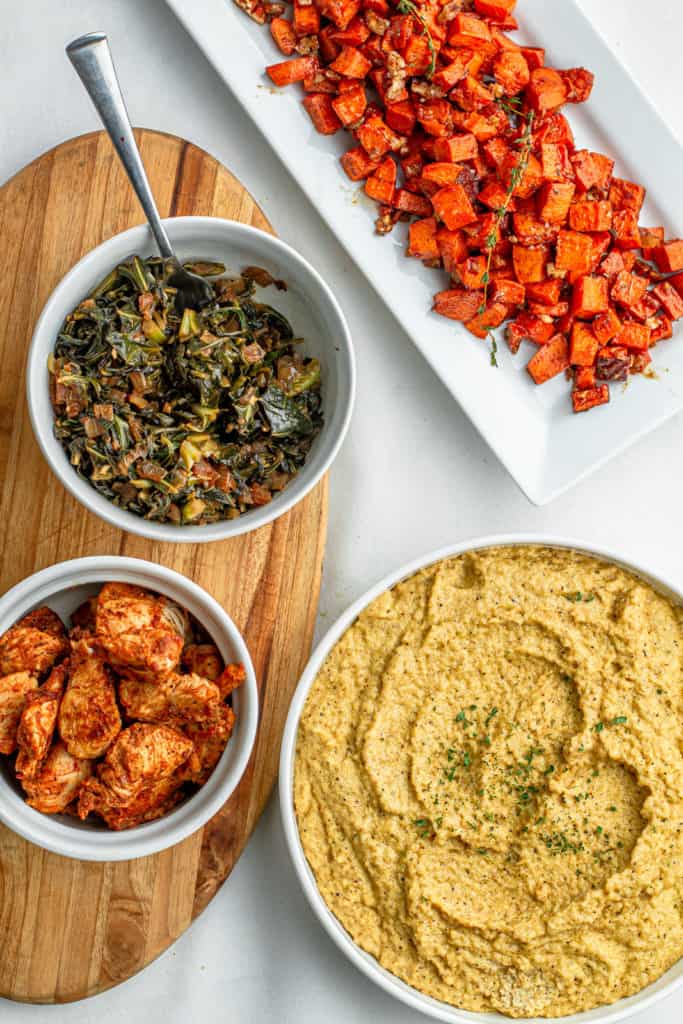 soul bowl ingredients: creamy fonio grits, collard greens, chicken bits and maple glazed sweet potatoes