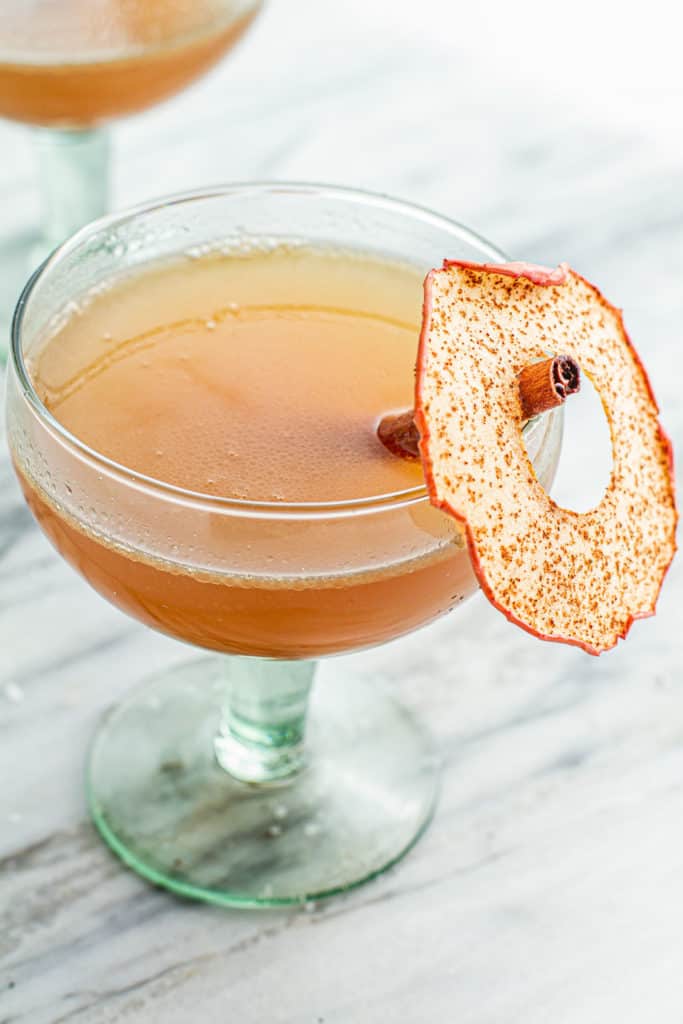 hot apple butter rum with apple chip garnish in glass