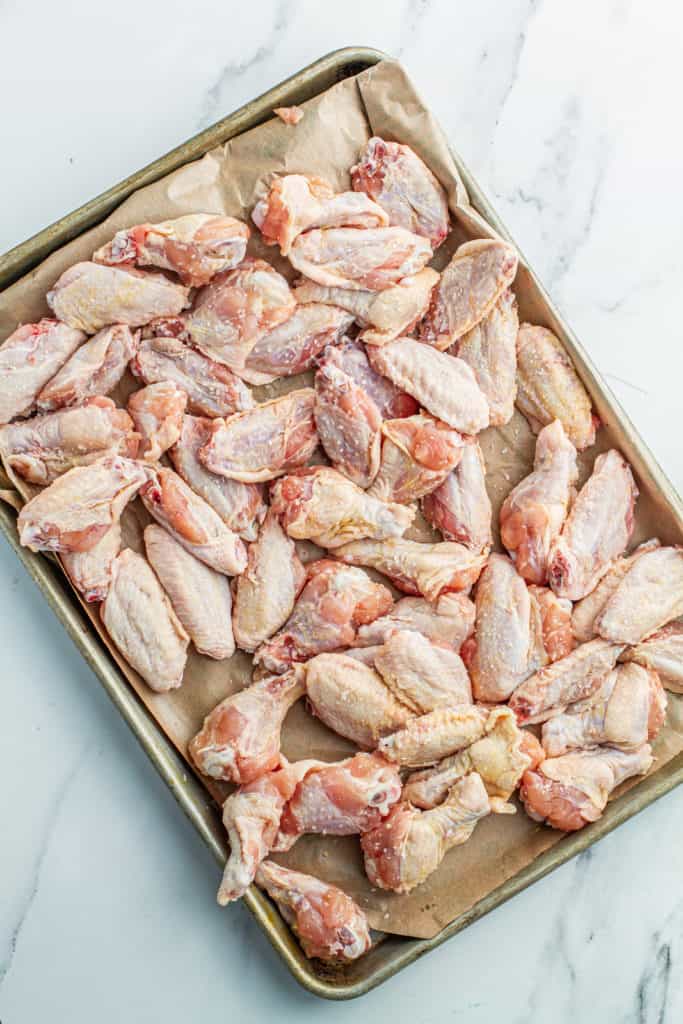 raw chicken wings on a sheet pan for air fryer
