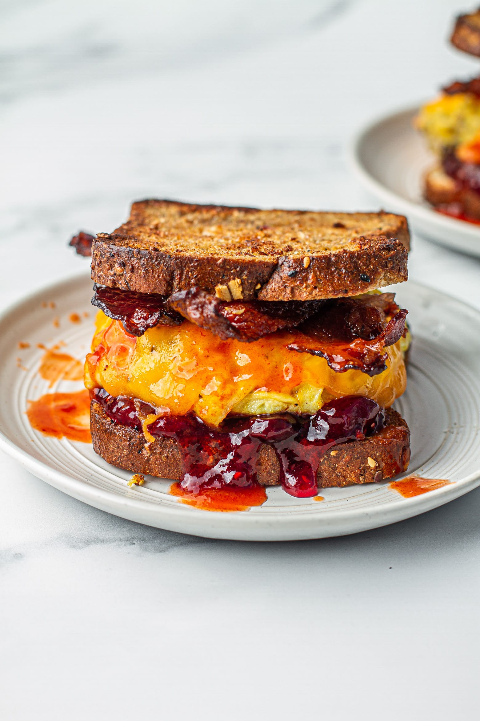 bacon egg and cheese sandwich on a white plate