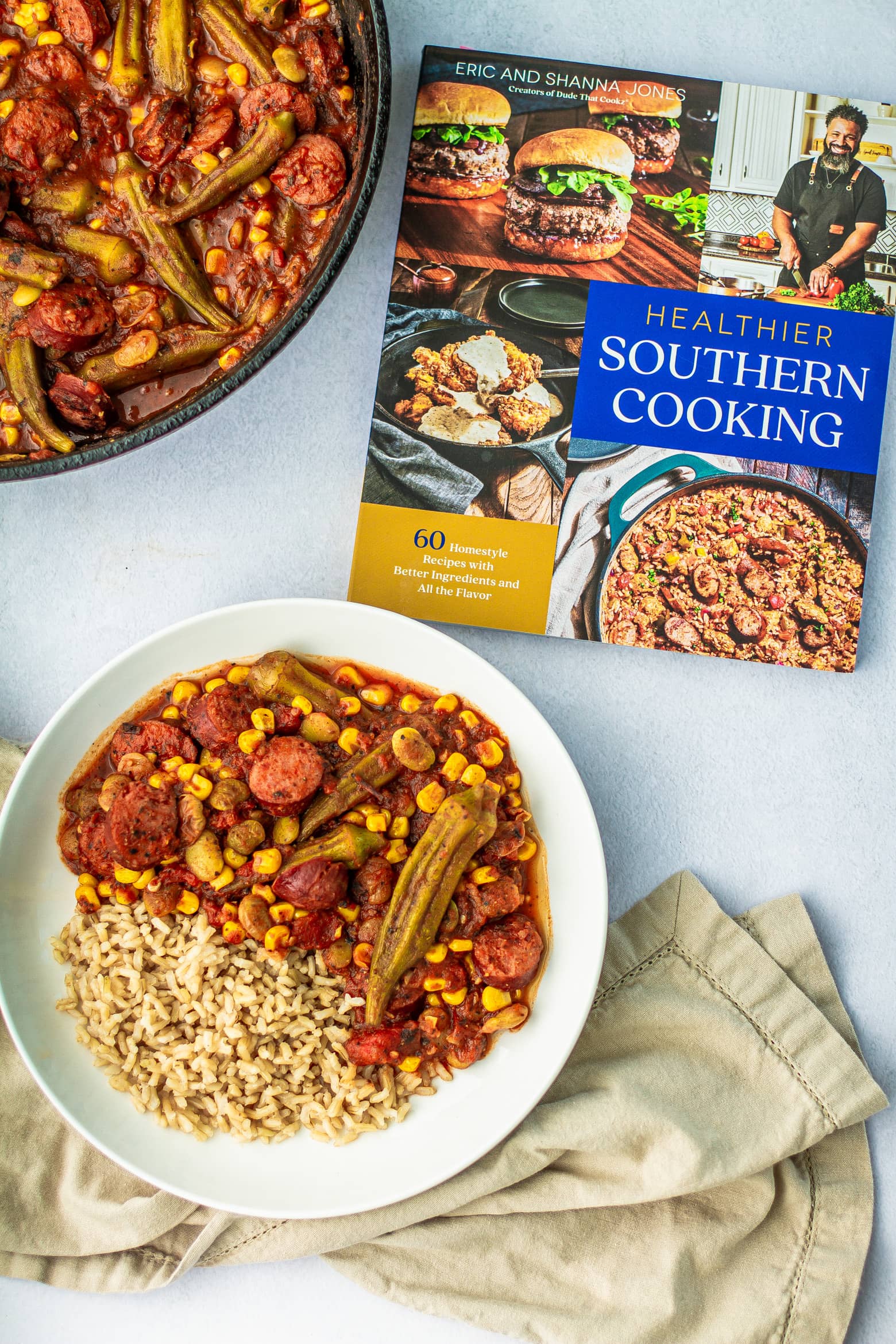 Overhead shoot of Creole Okra & Tomatoes in a bowl along with  Healthier Southern Cooking by Eric & Shanna Jones cookbook