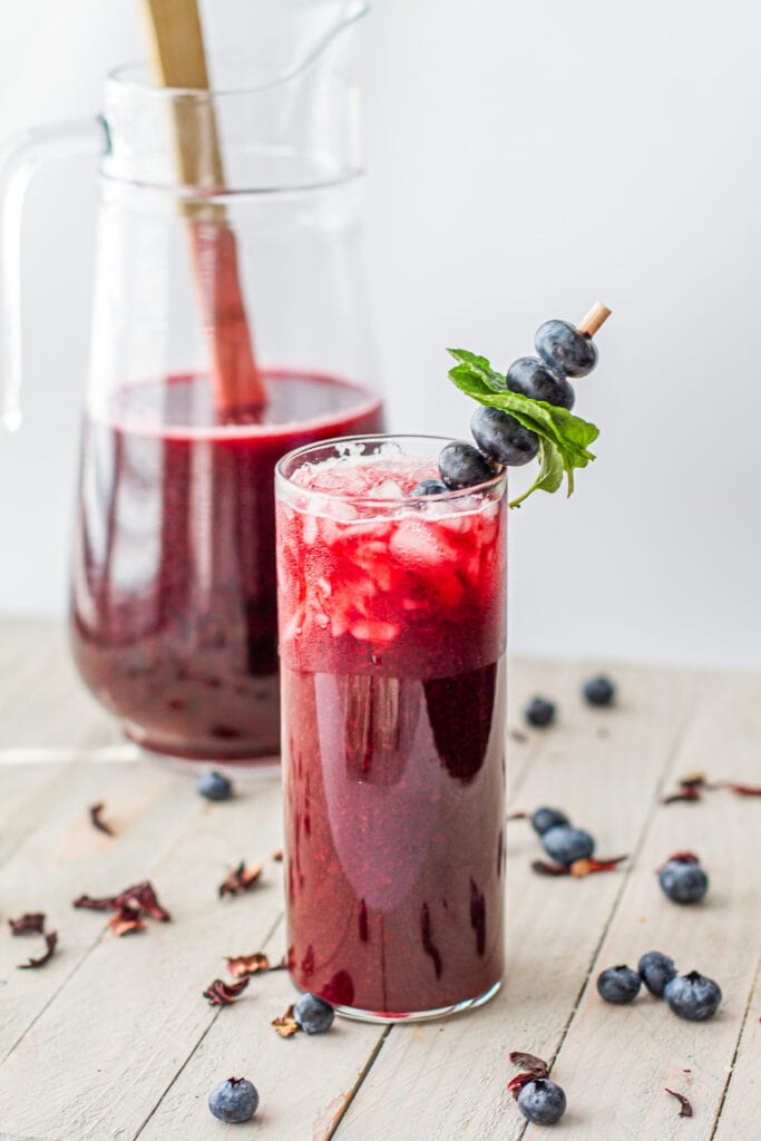 Hibiscus & Blueberry Agua Fresca in a pitcher and in a glass